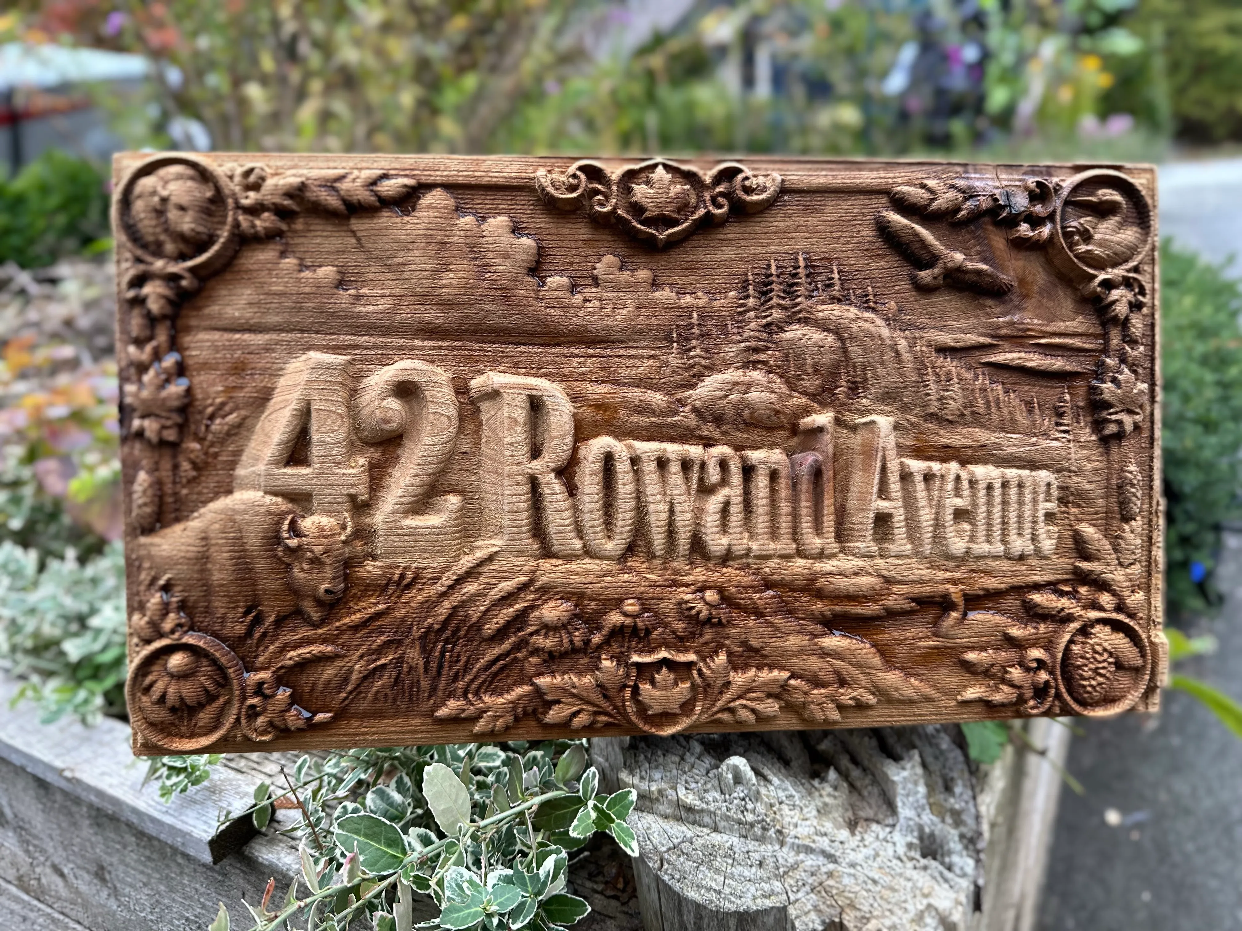 Prairie Heritage style: 42 Rowand Avenue sign with a bison, wheat, an eagle and maple-leaf crests